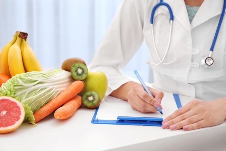 Nutritionist doctor writing diet plan on table nutritionist in Pattaya